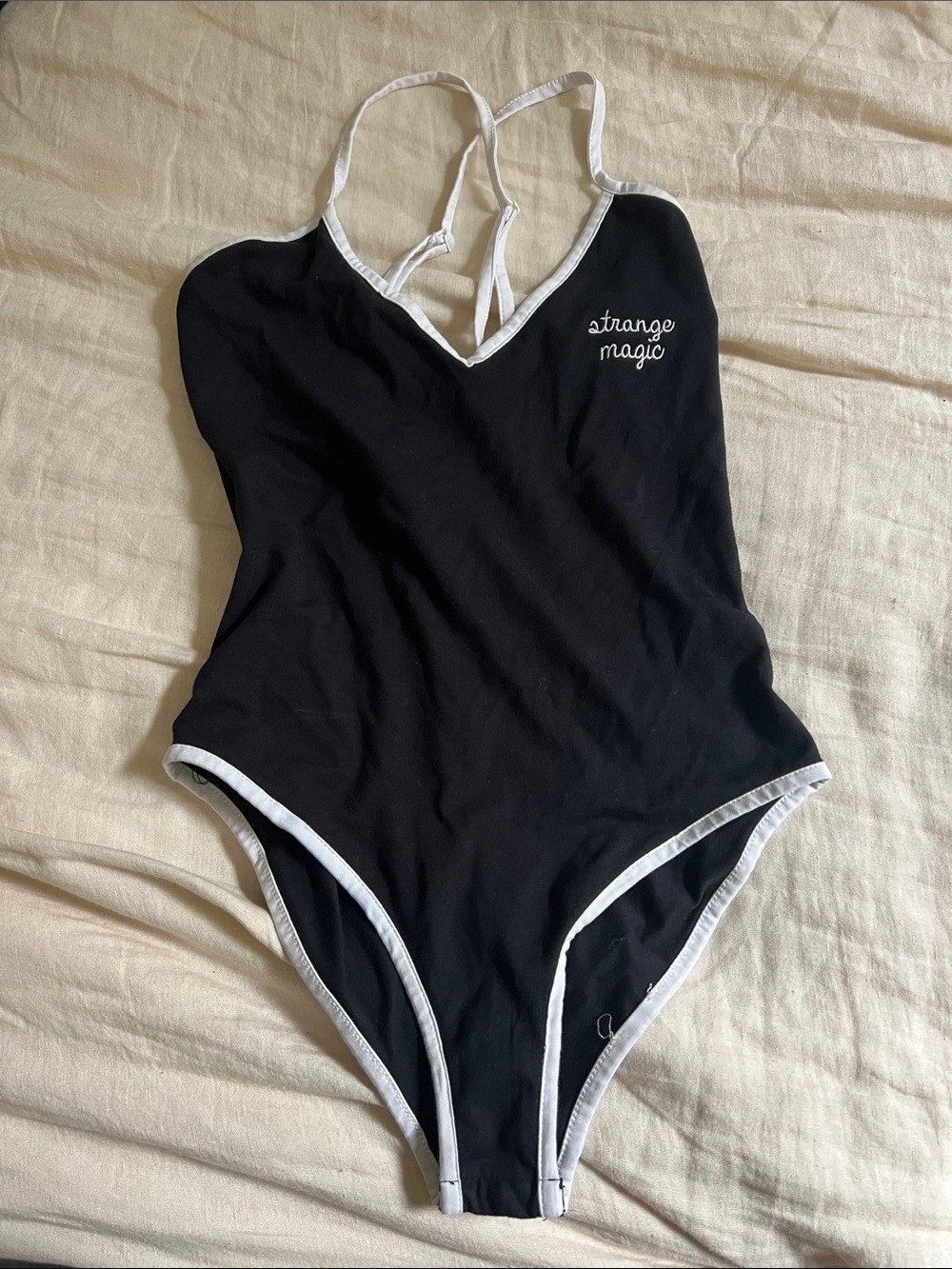 Camp Collection Black Bodysuit with White Trim and 'strange magic' Embroidery